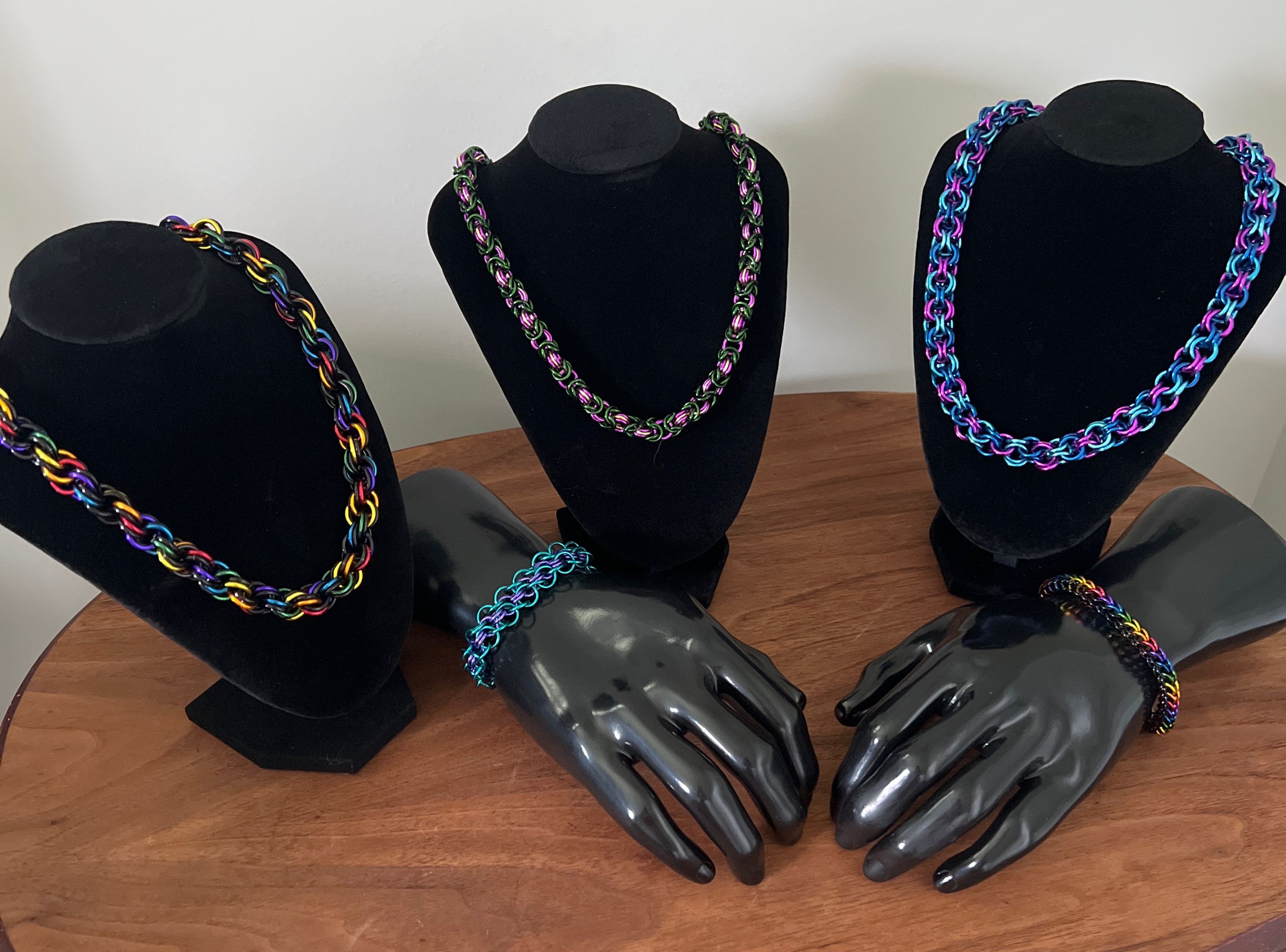 Necklaces on Busts on Wooden Table
